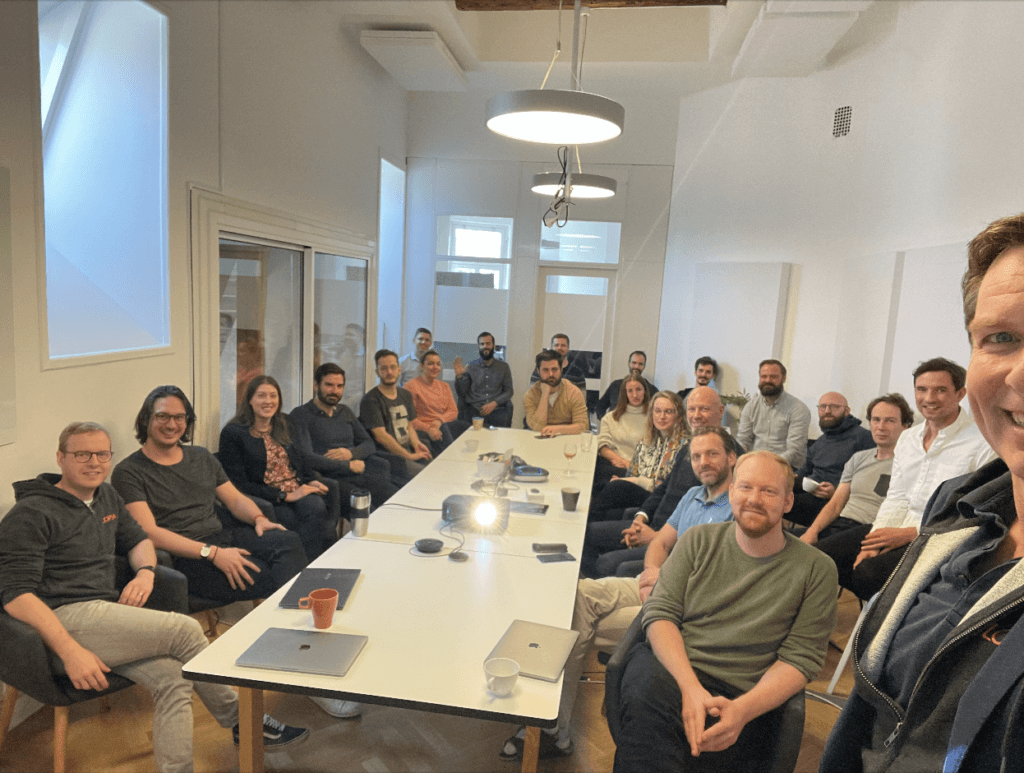 A group picture of smiling employees in a conference room